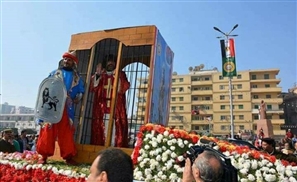 Why is There a Man in a Cage in Mansoura's National Day Parade?